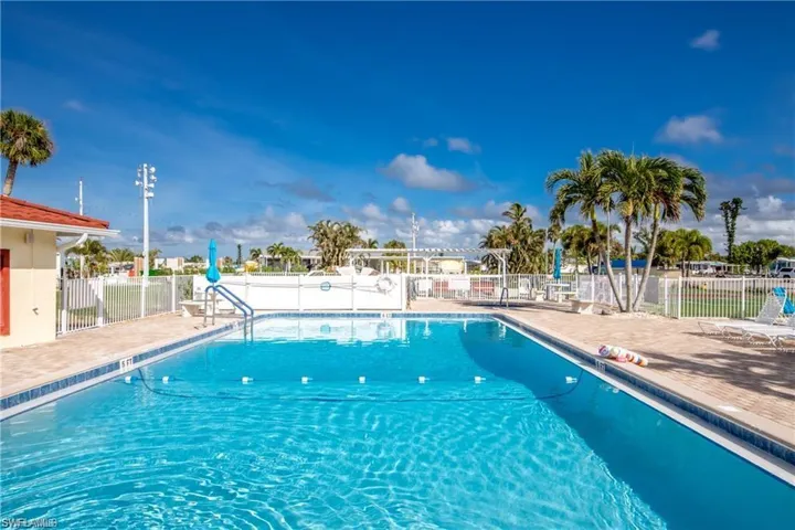 Community salt water pool with a patio