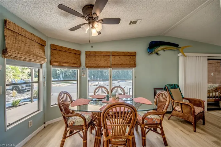 Dining area with ceiling fan and light wood-style floors