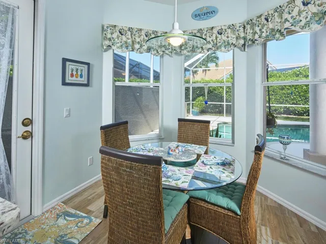 Breakfast nook with large windows overlooking the lush surroundings.