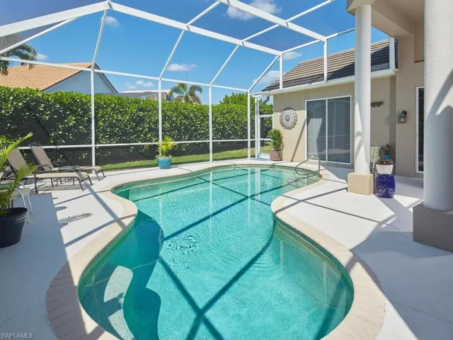 Sparkling pool with a private screened enclosure.