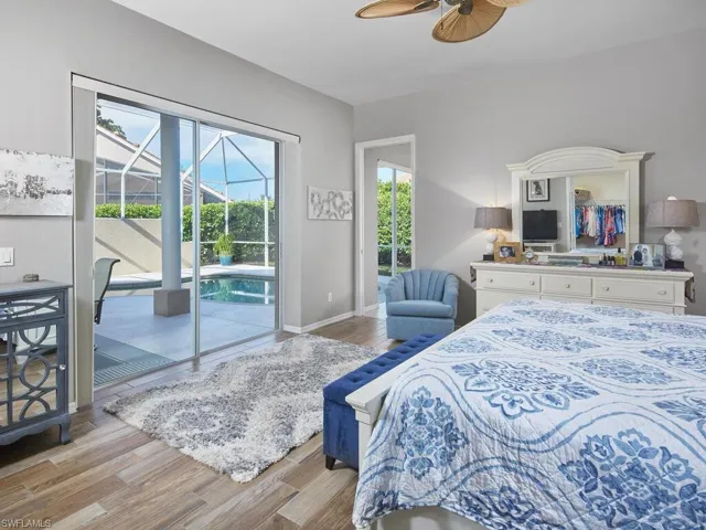 Spacious primary bedroom with large windows and peaceful views.