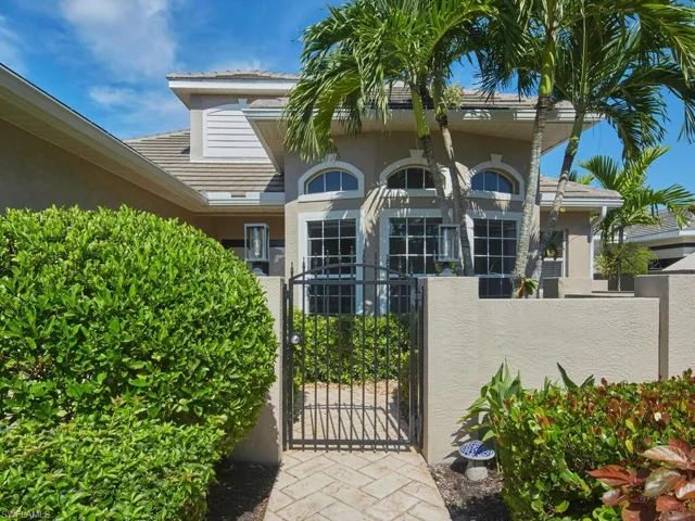 Charming entryway with tropical greenery.