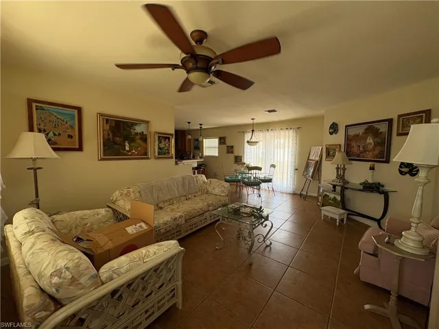 Living area with tile patterned flooring and a ceiling fan