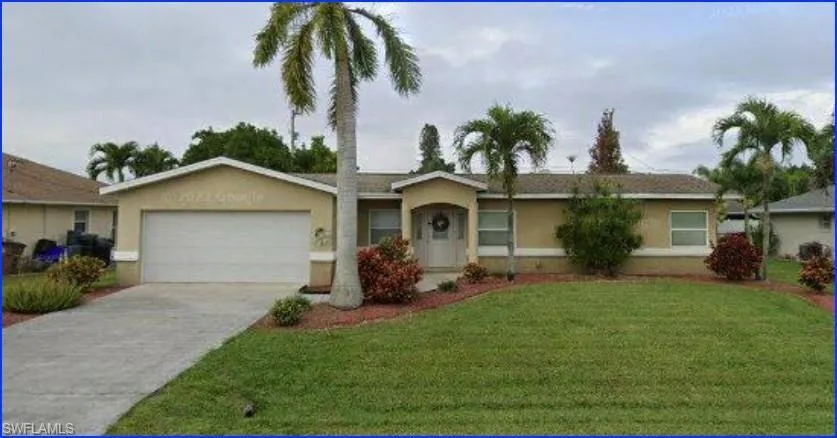 Ranch-style house with a front yard, stucco siding, concrete driveway, and an attached garage