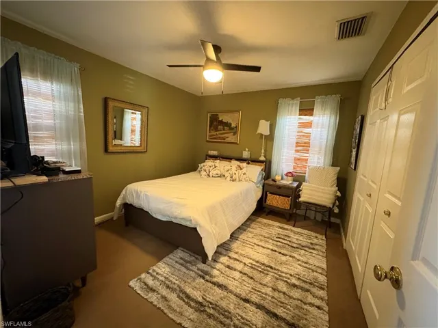 Bedroom featuring a closet, a ceiling fan, and carpet floors
