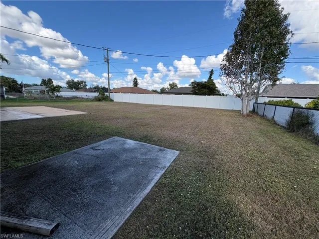 Fenced backyard with a patio