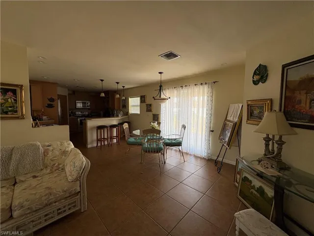 Dining area with dark tile patterned flooring and baseboards