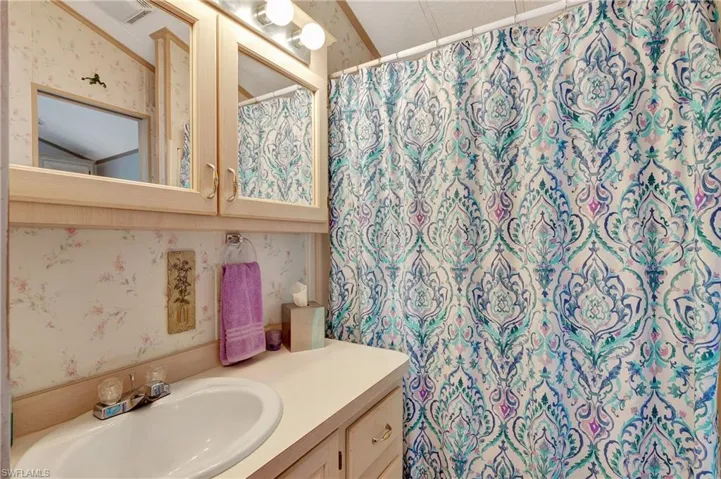 Bathroom with vanity and vaulted ceiling