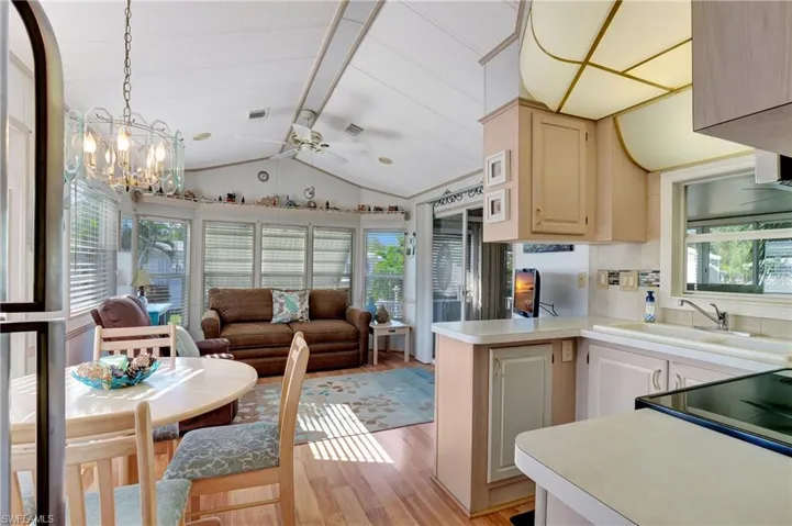 Kitchen featuring sink, light wood-type flooring, plenty of natural light, and kitchen peninsula