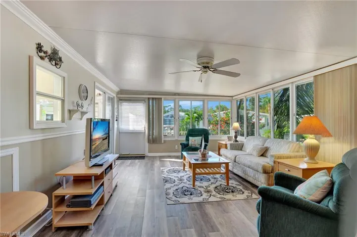 Living Room with ceiling fan and a wealth of natural light