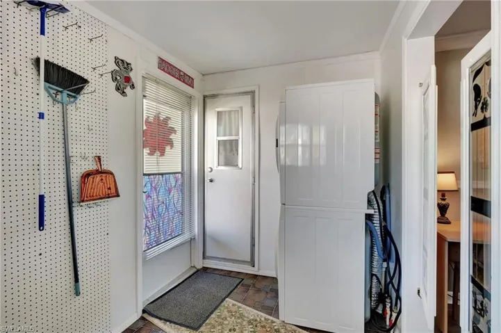 Doorway to outside featuring crown molding
