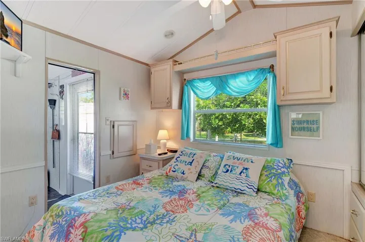 Bedroom featuring lofted ceiling, crown molding, and ceiling fan