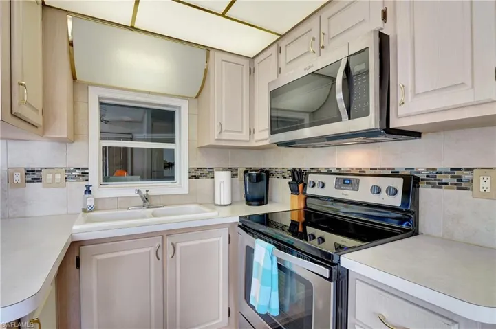 Kitchen featuring stainless steel appliances, sink, and tasteful backsplash