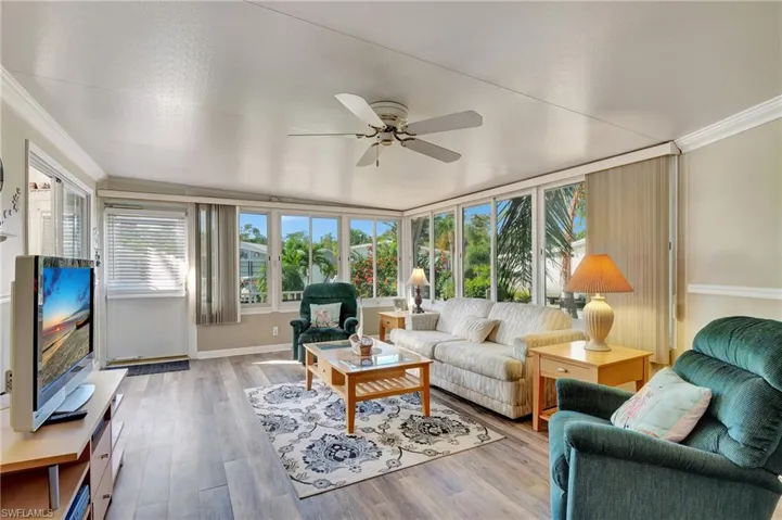 Living room featuring a healthy amount of sunlight and ceiling fan