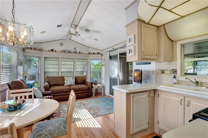 Kitchen with pendant lighting, light wood-type flooring, plenty of natural light, and sink