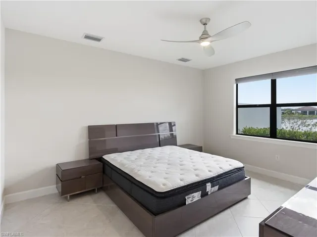 Bedroom featuring a ceiling fan and light tile patterned flooring