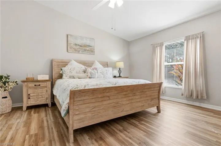 Bedroom featuring light wood-type flooring, a ceiling fan, and vaulted ceiling