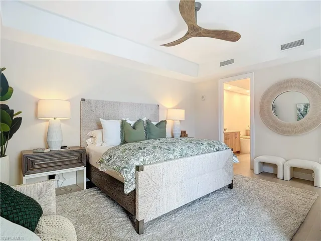 Bedroom with connected bathroom, hardwood / wood-style floors, and ceiling fan
