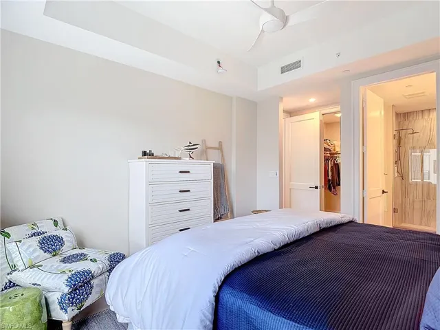 Bedroom featuring a closet, a spacious closet, and ceiling fan