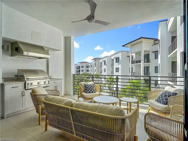 Balcony featuring area for grilling, an outdoor living space, an outdoor kitchen, and ceiling fan