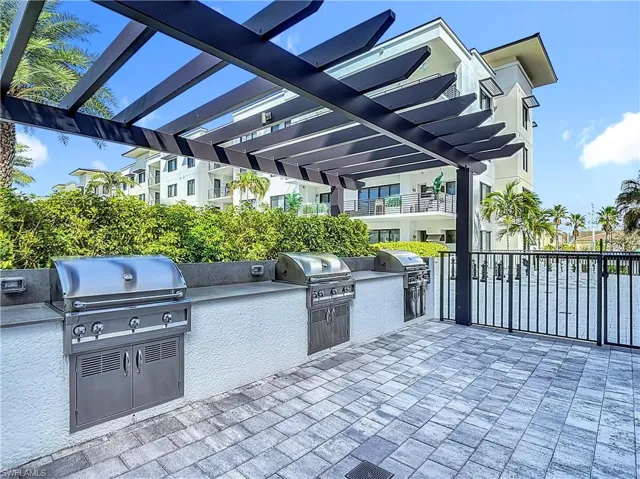 View of patio with a pergola, a grill, and exterior kitchen