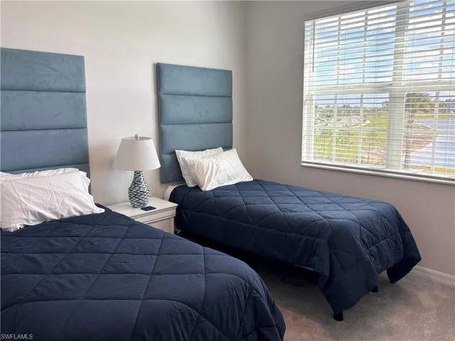 Carpeted bedroom with baseboards