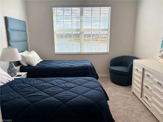 Bedroom featuring carpet flooring and baseboards