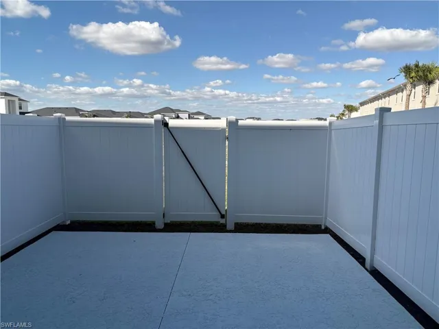 View of patio / terrace with a gate and a residential view