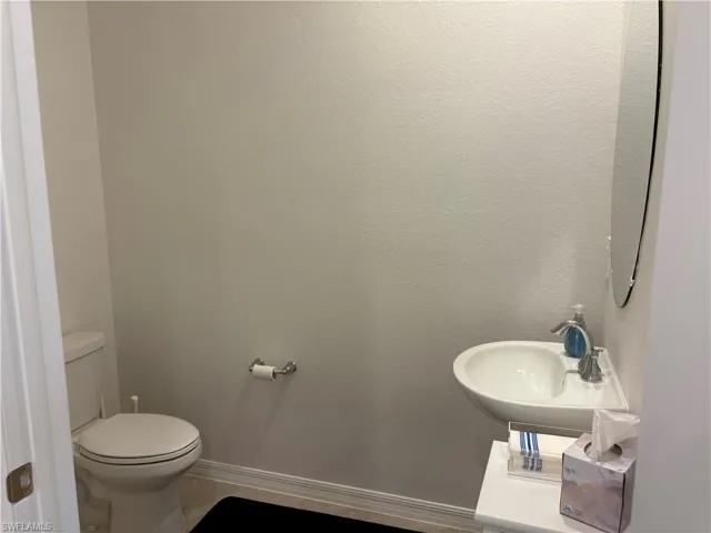 Half bathroom featuring baseboards and light tile patterned floors