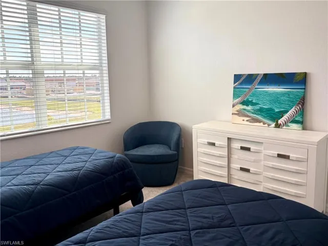 Bedroom with carpet flooring and a textured wall
