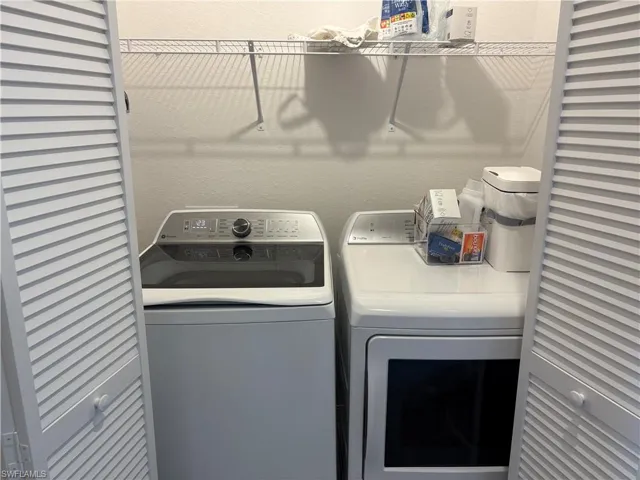 Laundry area with independent washer and dryer and a textured wall