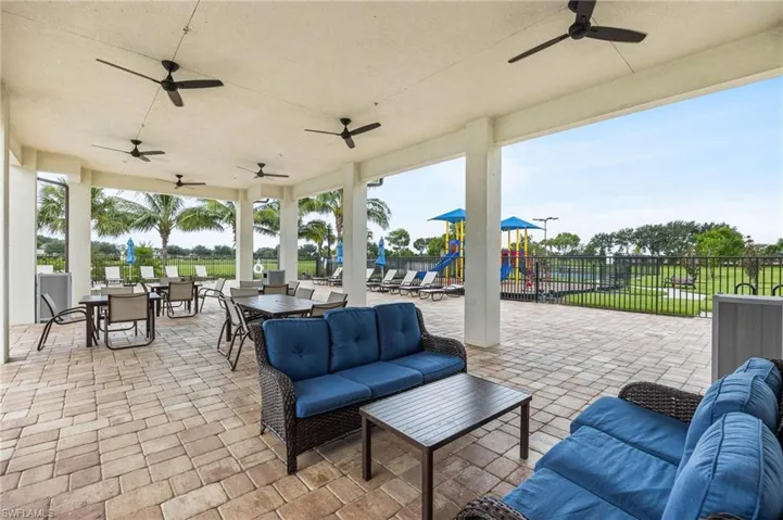 View of Club House patio / terrace featuring outdoor lounge area, ceiling fan, and a playground