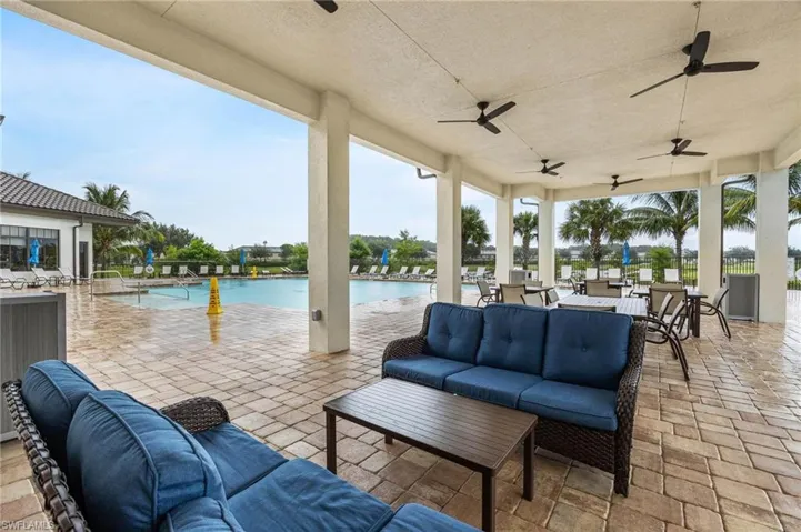 View of Club House patio / terrace featuring a water view, ceiling fan, a community pool, and outdoor lounge area