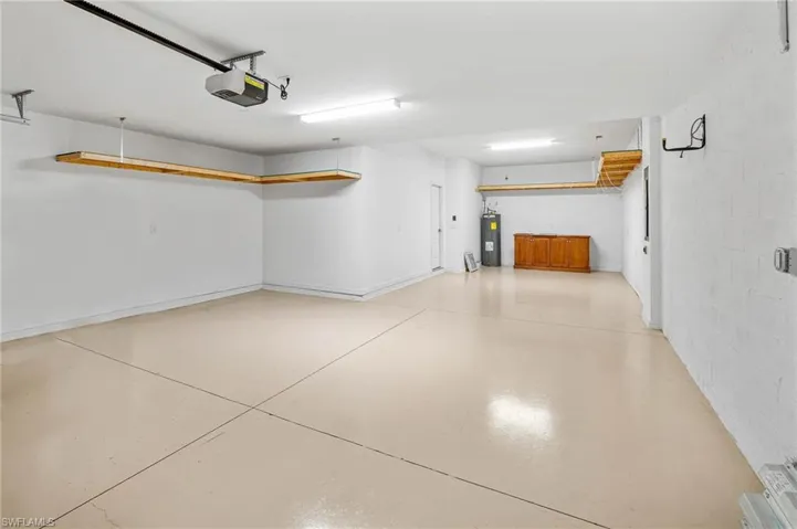 Garage with a garage door opener and electric water heater