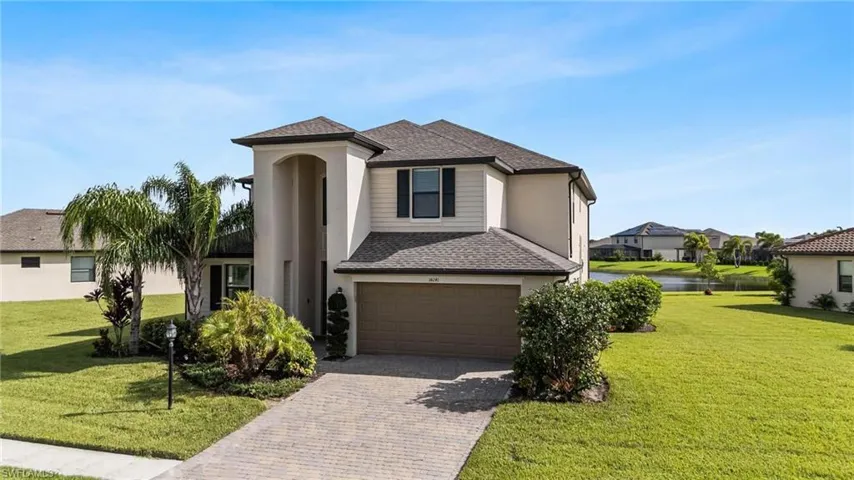 View of front facade with a garage and a front lawn