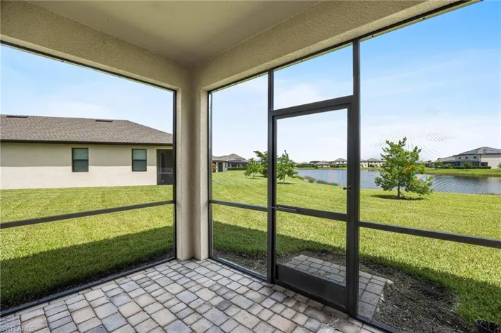 Unfurnished lanai sunroom featuring a water view