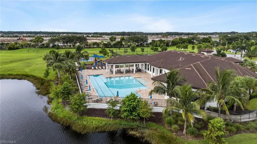 View of swimming pool featuring a yard, a patio, and a water view