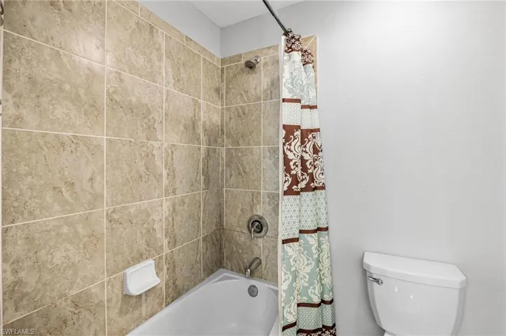 Bathroom with shower / bath combo and toilet