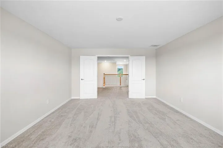 Unfurnished bedroom featuring light carpet