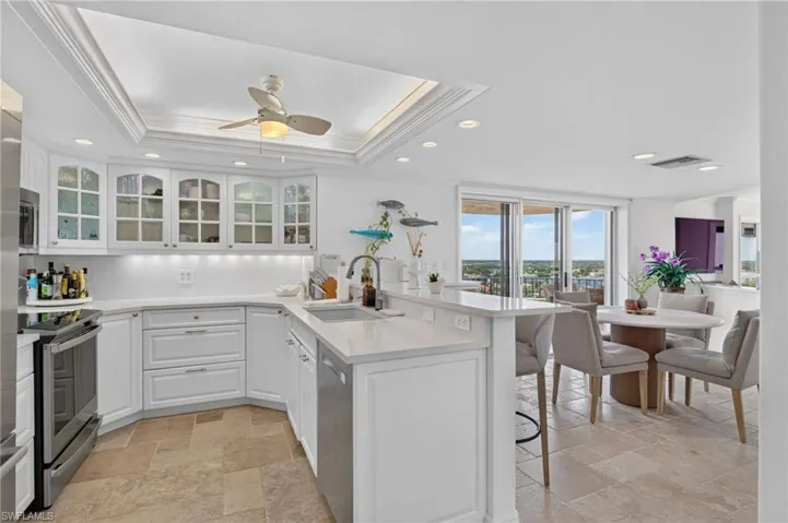 Kitchen opens to informal dining area and balcony overlooking the inner bay