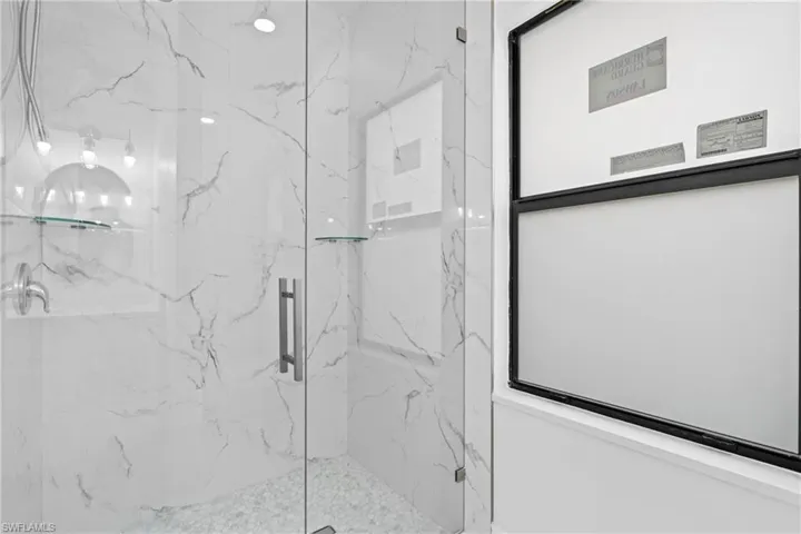 Full bathroom with a marble finish shower
