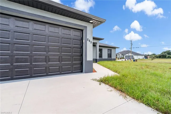 Garage featuring concrete driveway