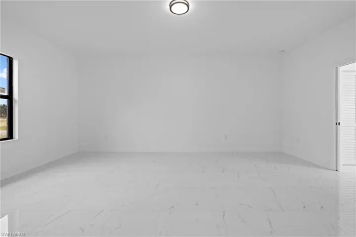 Unfurnished room featuring baseboards