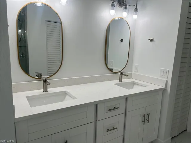 Bathroom with double vanity and a closet
