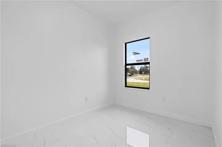 Empty room with light marble finish floors and baseboards