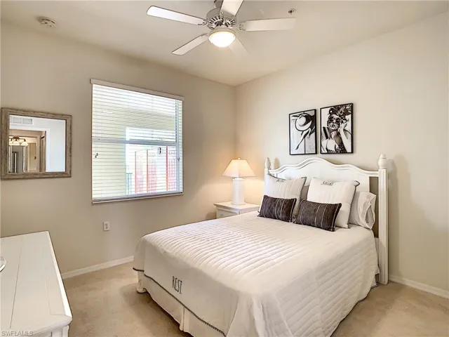 Bedroom featuring ceiling fan and light carpet