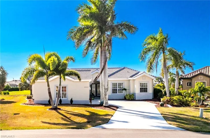 Mediterranean / spanish-style house with stucco siding, a front yard, and concrete driveway