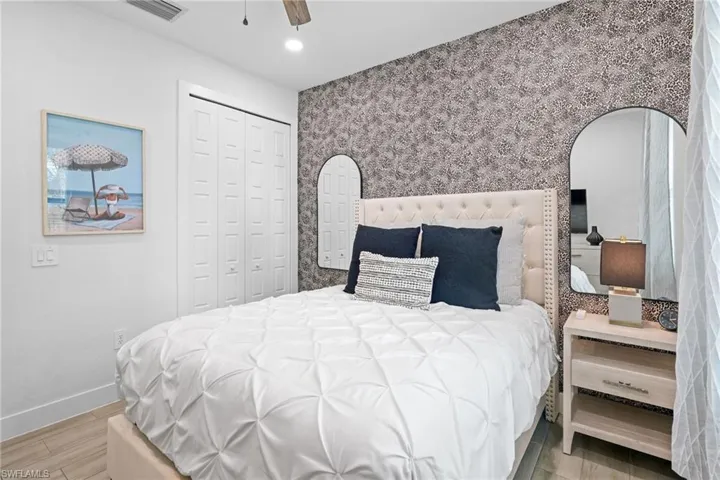 Bedroom featuring wood tiled floors, a closet, ceiling fan, and recessed lighting