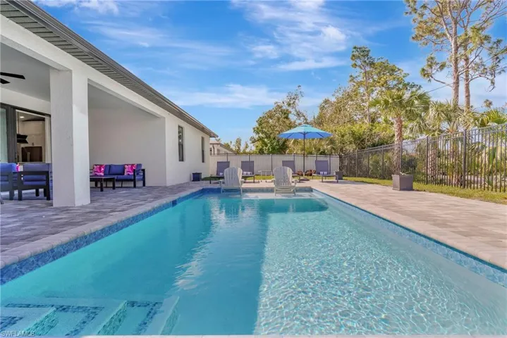 View of swimming pool with a patio, a fenced backyard, and outdoor lounge area