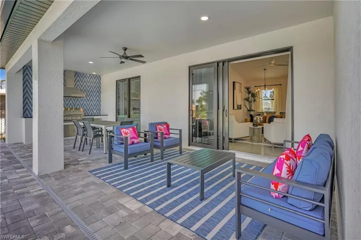 View of patio / terrace with area for grilling, ceiling fan, outdoor lounge area, and outdoor dining space